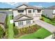 Aerial view of a beautiful two-story home with manicured landscaping, a paved driveway, and a three-car garage at 12829 Tortoise Shell Pl, Riverview, FL 33579