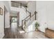 Bright foyer with beautiful staircase, wood floors, and natural light creating an inviting entryway at 12829 Tortoise Shell Pl, Riverview, FL 33579