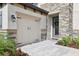 Close up exterior with stone, landscaping, walkway, two car garage, and decorative entry door at 12829 Tortoise Shell Pl, Riverview, FL 33579