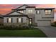 Two-story home with stone accents, neutral siding, shutters, manicured lawn, and a two-car garage at 12829 Tortoise Shell Pl, Riverview, FL 33579