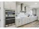 Modern kitchen featuring stainless steel appliances, gray cabinets, white countertops, and a decorative backsplash at 12829 Tortoise Shell Pl, Riverview, FL 33579