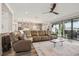 Open concept living room featuring wood floors, a large sectional sofa, and a view to the backyard at 12829 Tortoise Shell Pl, Riverview, FL 33579