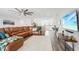 Spacious living room featuring hardwood floors, leather furniture, and a ceiling fan at 12829 Tortoise Shell Pl, Riverview, FL 33579