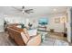 Comfortable living room featuring hardwood floors, modern decor, and a ceiling fan at 12829 Tortoise Shell Pl, Riverview, FL 33579