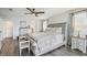 Well-lit main bedroom features a ceiling fan, a decorative rug and an upholstered bed frame at 12829 Tortoise Shell Pl, Riverview, FL 33579