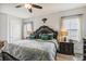 A large bedroom featuring ornate wood furniture and decor, including a decorative headboard at 12829 Tortoise Shell Pl, Riverview, FL 33579