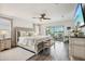 Bright main bedroom with decorative furniture, wood-look floors, and sliding glass doors to the lanai at 12829 Tortoise Shell Pl, Riverview, FL 33579