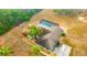 Aerial view of house, fenced backyard, and screened-in pool at 13128 Hazelcrest St, Spring Hill, FL 34609