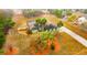 Overhead photo of a one-story home featuring a lush lawn, palm trees, long driveway, and fenced yard at 13128 Hazelcrest St, Spring Hill, FL 34609