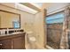 Bathroom featuring a vanity with a dark countertop and a tiled walk-in shower at 13128 Hazelcrest St, Spring Hill, FL 34609