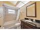 Bathroom featuring a vanity with dark countertop, toilet, tub and shower with tile surround at 13128 Hazelcrest St, Spring Hill, FL 34609