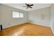 Bedroom with hardwood floors, fan, and natural light from the window at 13128 Hazelcrest St, Spring Hill, FL 34609