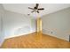 Bedroom featuring hardwood floors, a ceiling fan, and a closet at 13128 Hazelcrest St, Spring Hill, FL 34609