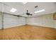 Spacious garage with a ceiling fan, laminate wood floor and natural light at 13128 Hazelcrest St, Spring Hill, FL 34609