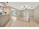 Open concept living room with tile floors, a ceiling fan, and a view of the pool at 13128 Hazelcrest St, Spring Hill, FL 34609