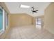 A bright and airy living room with skylight, ceiling fan, and tile flooring at 13128 Hazelcrest St, Spring Hill, FL 34609