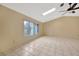 Sunlit living area with skylight, ceiling fan, and a large window at 13128 Hazelcrest St, Spring Hill, FL 34609