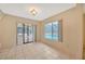 Tile floored living room with a ceiling fan, backyard view and access to the lanai at 13128 Hazelcrest St, Spring Hill, FL 34609