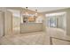 Open floorplan view from living room into kitchen and lanai; tiled floors at 13128 Hazelcrest St, Spring Hill, FL 34609