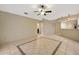 Open living area with tile floors, ceiling fan, and view into other rooms at 13128 Hazelcrest St, Spring Hill, FL 34609