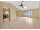 Spacious living area featuring a ceiling fan, skylight, and view to the kitchen at 13128 Hazelcrest St, Spring Hill, FL 34609