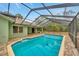 Inviting screened-in pool with a brick-paved deck, perfect for outdoor relaxation and entertaining at 13128 Hazelcrest St, Spring Hill, FL 34609