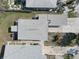 Aerial roof shot of a single-Gathering home highlighting a backyard seating area at 13313 2Nd E St, Madeira Beach, FL 33708