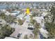 Aerial neighborhood view of the property close to the water and a car parked in the driveway at 13313 2Nd E St, Madeira Beach, FL 33708