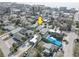 An aerial view of a neighborhood near the beach with palm trees and quaint houses at 13313 2Nd E St, Madeira Beach, FL 33708