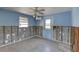 Bedroom with terrazzo floors, bright blue walls, and door to the outside at 13313 2Nd E St, Madeira Beach, FL 33708