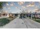 A single-story home featuring a carport, palm trees, and a concrete driveway at 13313 2Nd E St, Madeira Beach, FL 33708