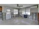 Spacious living room with exposed block walls, ceiling fan and natural light at 13313 2Nd E St, Madeira Beach, FL 33708