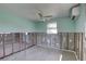 Bright, airy living room with terrazzo flooring and window, ready for transformation at 13313 2Nd E St, Madeira Beach, FL 33708