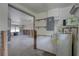 Open-concept living room with exposed studs and ceiling fans, awaiting restoration and personalization at 13313 2Nd E St, Madeira Beach, FL 33708