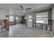 Spacious living room with exposed block walls, ceiling fan and natural light at 13313 2Nd E St, Madeira Beach, FL 33708