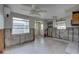 Spacious living room with exposed block walls, ceiling fan and natural light at 13313 2Nd E St, Madeira Beach, FL 33708