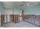 Spacious living room featuring ceiling fan and terrazzo flooring, prepped for remodeling at 13313 2Nd E St, Madeira Beach, FL 33708