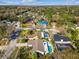 Neighborhood aerial showcasing homes with private pools, mature trees, and quiet residential streets at 15109 Winterwind Dr, Tampa, FL 33624