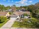 Beautiful aerial view of a home with mature landscaping, lush lawn and a wide driveway at 15109 Winterwind Dr, Tampa, FL 33624