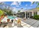 Backyard with pool, patio and golden chair set at 15109 Winterwind Dr, Tampa, FL 33624