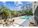 Landscaped backyard with pool and a golden chair set at 15109 Winterwind Dr, Tampa, FL 33624