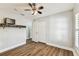 Bedroom with wood-look floors, neutral walls, ceiling fan and closet at 15109 Winterwind Dr, Tampa, FL 33624