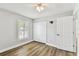 Bedroom with wood-look floors, neutral walls, bright window and closet at 15109 Winterwind Dr, Tampa, FL 33624