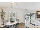 Cozy dining area with view to pool featuring a bright window with plantation shutters and stylish furniture at 15109 Winterwind Dr, Tampa, FL 33624