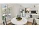 Bright breakfast nook with plantation shutters, table for four, and view of a backyard pool at 15109 Winterwind Dr, Tampa, FL 33624