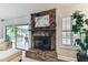 Close-up of stone fireplace with mantel, decor, and view of the patio at 15109 Winterwind Dr, Tampa, FL 33624