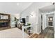 Bright hallway with stone fireplace, TV, and view of the bathroom at 15109 Winterwind Dr, Tampa, FL 33624