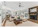 Bright living room with fireplace, ceiling fan, and sliding doors to the patio at 15109 Winterwind Dr, Tampa, FL 33624