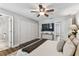 Well-lit main bedroom with a large closet, mounted TV and stylish, modern decor at 15109 Winterwind Dr, Tampa, FL 33624