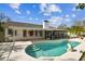 Backyard pool with covered patio and built-in steps at 15109 Winterwind Dr, Tampa, FL 33624